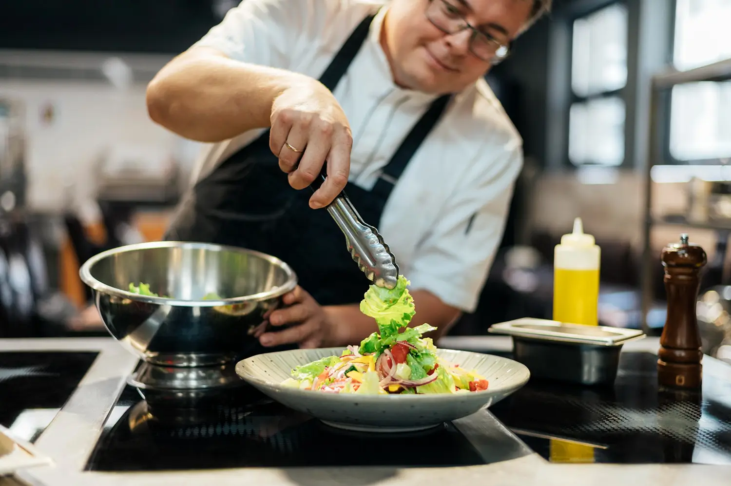 Professional chef instructor teaching nutritional cooking techniques to men in residential addiction treatment in Flagstaff, Arizona