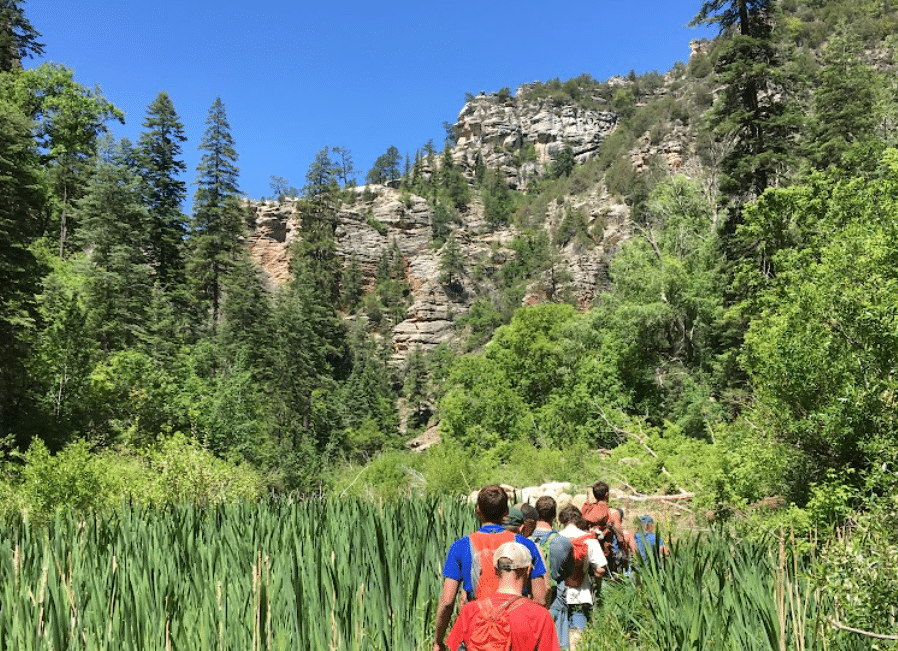 Young men in the Back2Basics aftercare program hiking together in the Flagstaff wilderness.